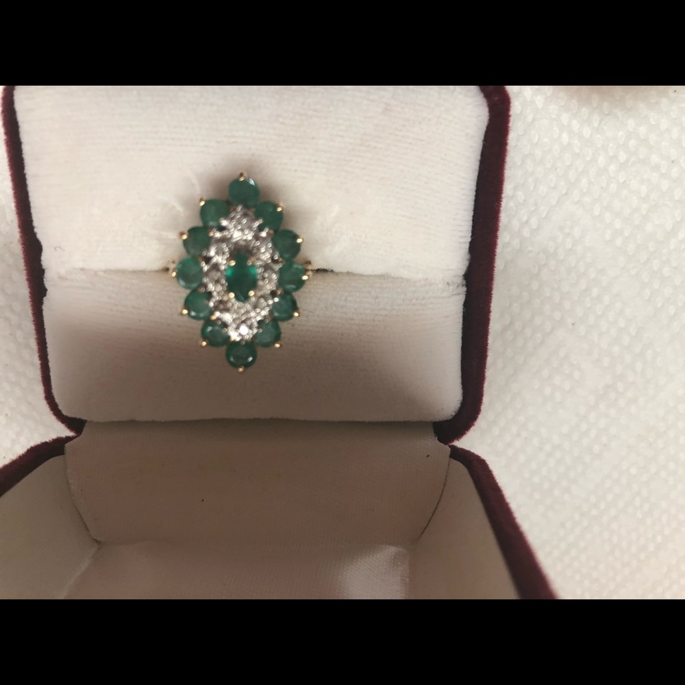 2  x 6 oval cut emerald surrounded by 10 diamonds